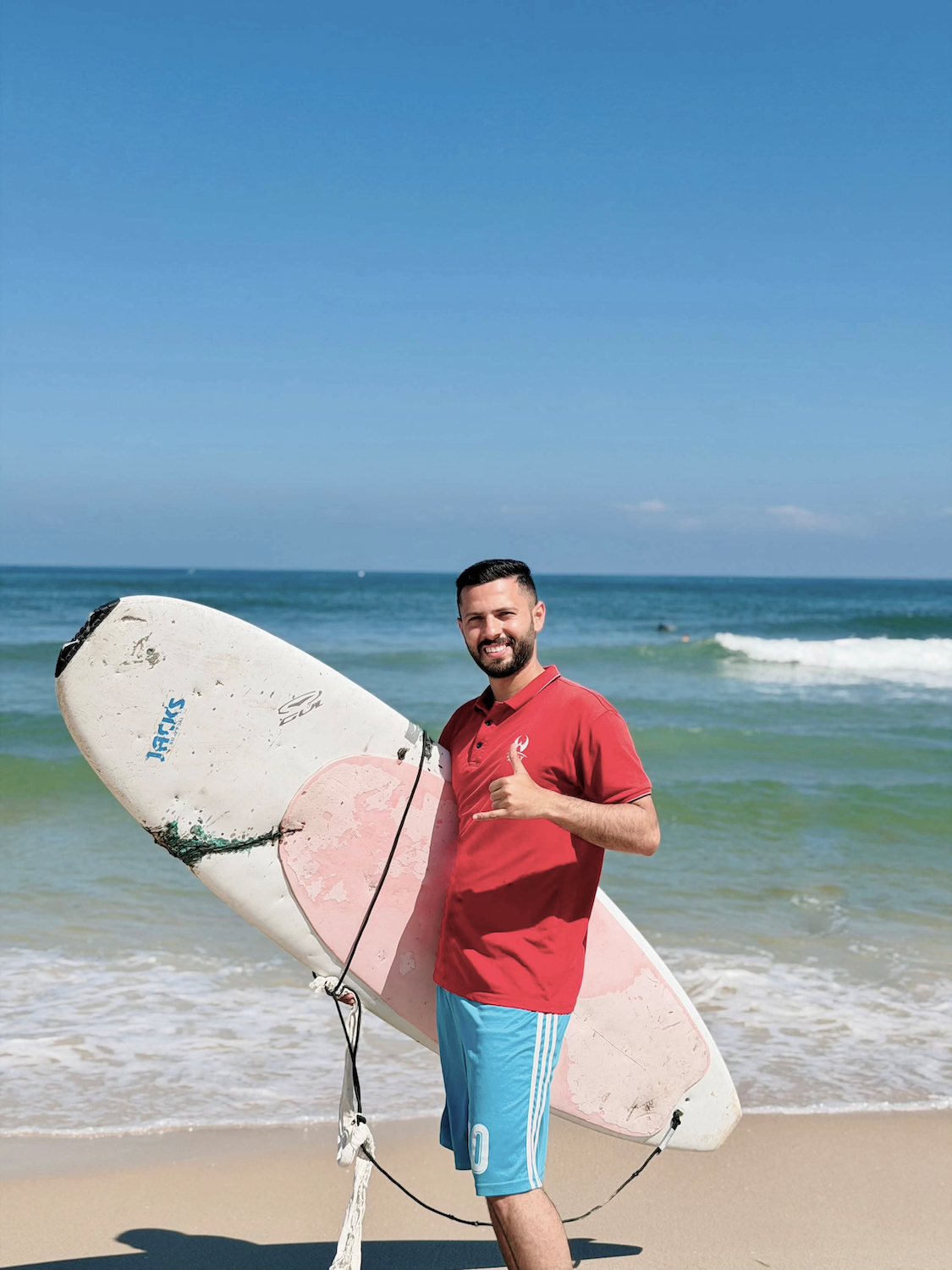 Abdullah Abu Ghanem with his surfboard.png